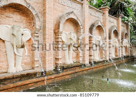 Many of white  elephant statues fountain in front of the entrance to the zoo.