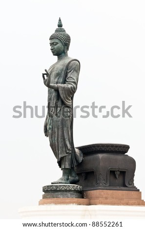 Large black statue of Buddha in the white background.