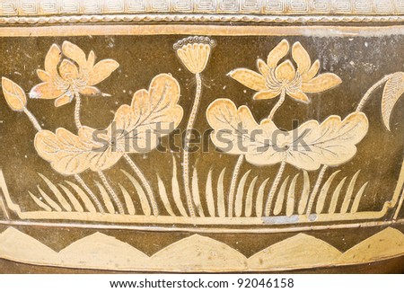 Lotus flower patterns on the clay jar in Thai style.