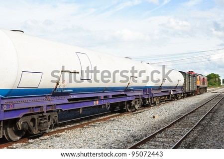 Gas tanker wagon in freight train on station.