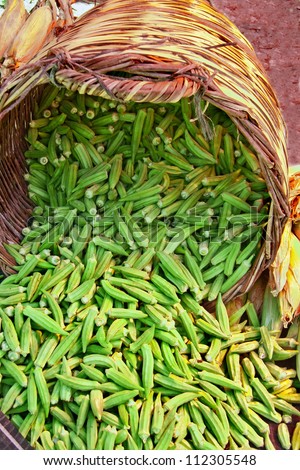 Organic Okra Spilling From A Basket  At A Street Market (Lady Fingers)