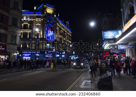 LONDON, UK - NOVEMBER 15: people enjoy the nightlife in Leicester Sq in London on November 15, 2014. Leicester Sq is the prime location in London for cinemas and world leading film premiers.