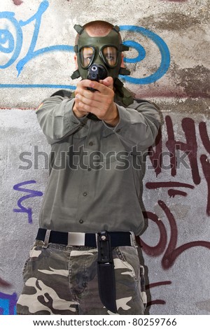 man with gas mask and gun