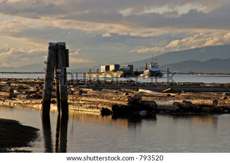 tugboat and logs on river