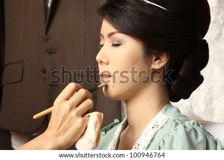 beautiful bride having her makeup for wedding day