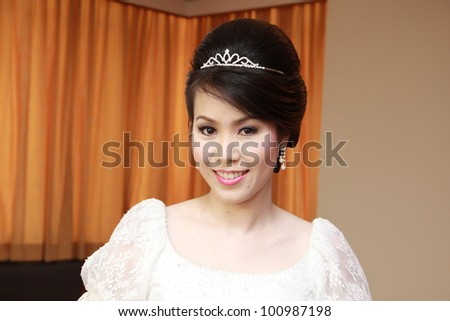 Slim beautiful woman wearing luxurious wedding dress with diamond crown, get ready for wedding party