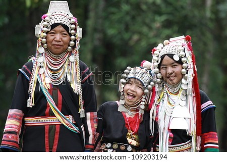 CHIANG RAI, THAILAND - OCT 1 : Akha family with traditional clothes and silver jewelery in akha hitt tribe minority village on October 1, 2011 in Chiang Rai, Thailand.