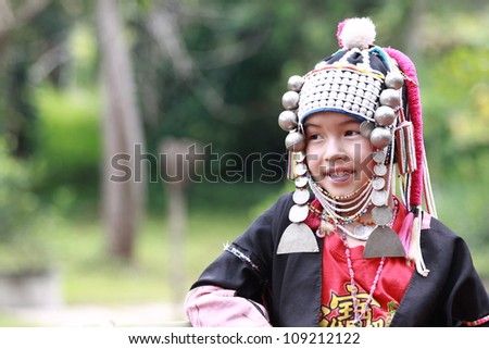 CHIANG RAI, THAILAND - OCT 1 : Akha girl with traditional clothes and silver jewelery in akha hitt tribe minority village on October 1, 2011 in Chiang Rai, Thailand.