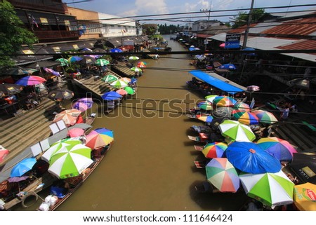 SAMUT SONGKHRAM, THAILAND - OCTOBER 27 : Ampahwa floating market with tourists and vendors, selling and buying food, fruit, and vegetable on October 27, 2012 in Samut Songkhram, Thailand.