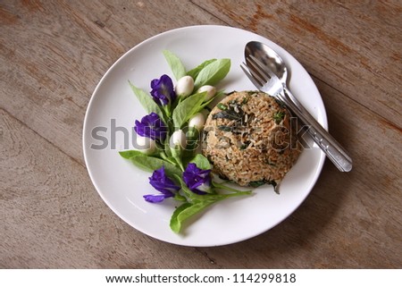 Closeup of Thai food. Fried rice with mixed vegetable and meat, decorate with flowers