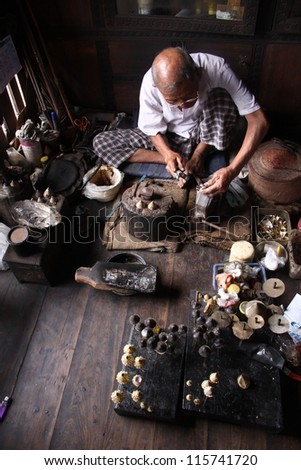 CHIANG MAI - OCTOBER 8: Unidentified man works with traditional method of making ancient hairpin for souvenir on October 8, 2012 in Chiang Mai, Thailand.