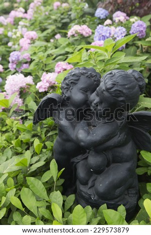 Hydrengea flowers with cupid statue