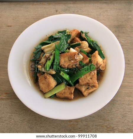 Thai food. fried tofu stir with garlic leafs, pepper, and sauce