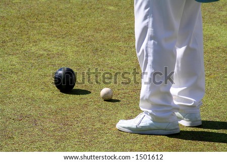 Bowling player and balls, on the playing ground