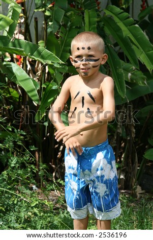 kid dancing tribal dance with ethnic makeup