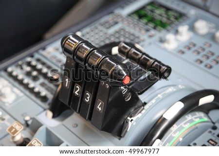 four jet airplane throttles in the cockpit