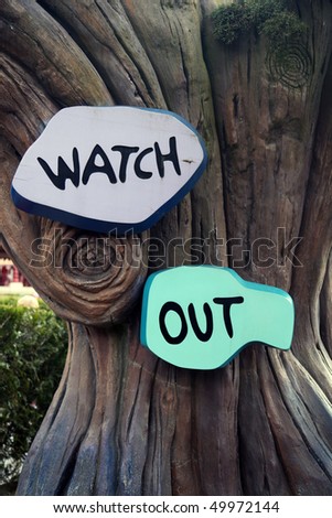 watch out sign on a tree