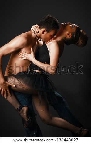 romantic tango dancing couple on black. naked torso