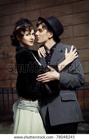 Retro styled fashion portrait of a young couple. Clothing and make-up in 1920s style.