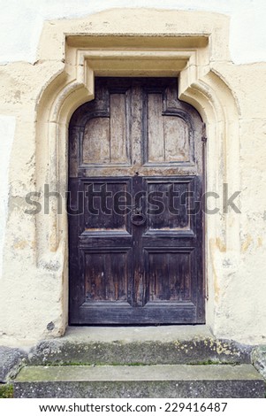 old wood door with metal knob  in Prejmer fortified church, Brasov county, Romania