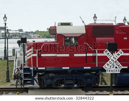 Red freight train going through a crossing