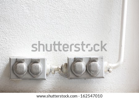 Old dirty electrical outlets on the white wall