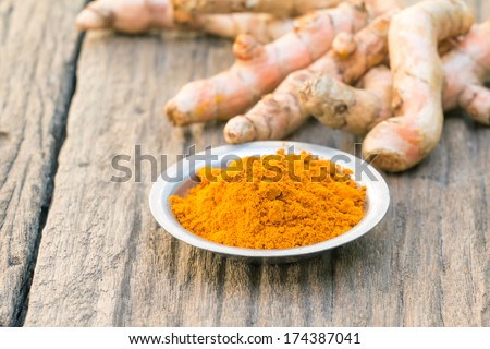 Fresh Turmeric Root, And Turmeric Powder On Wood Background- Shallow Depth Of Field