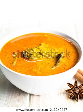 Spicy beef curry on wood background