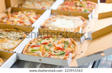 Pizza in box at the kitchen