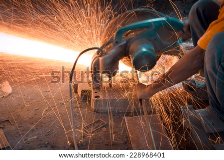 Man cutting and welding at work shop