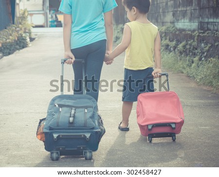 schoolgirl holding her young brother and walking to school with school bag , back to school concept, filtered images