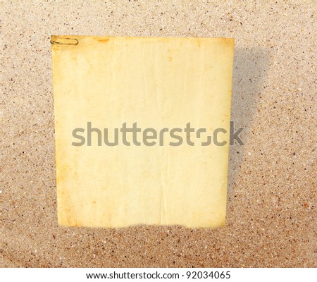 Old paper board on sand