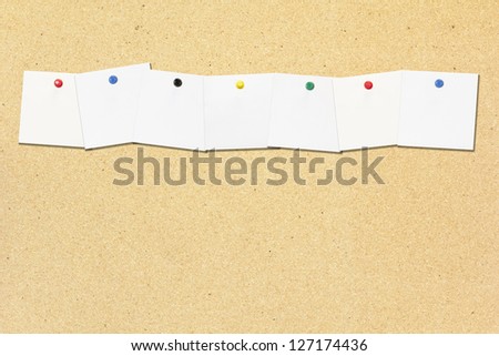 Row of empty note paper note on cork board