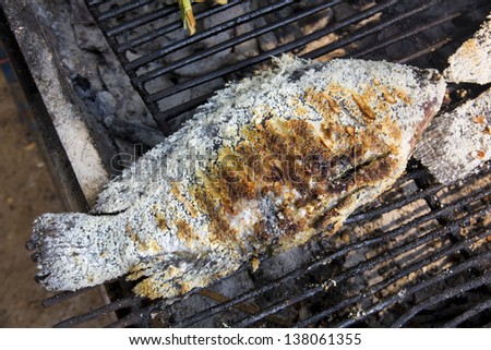 Fish cover on skin by salt grill on the stove