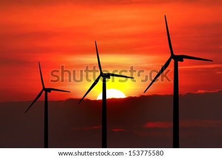 Wind turbine silhouette on sunset background