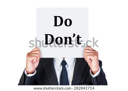 Say Do and Don\'t word on paper shown by business man isolated on white background