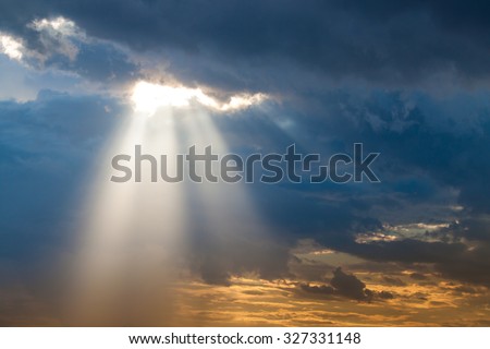 sun ray light through down from rain cloud during sunset time