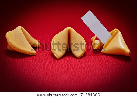 Three fortune cookies, one broken with blank message on red background.