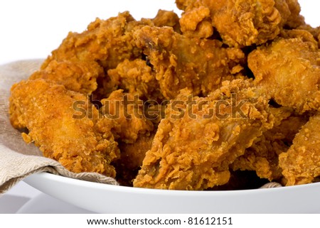 Plate of crispy fried chicken wings and drumsticks.