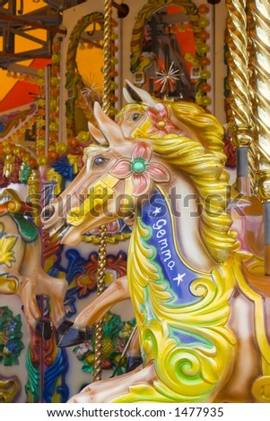 Brightly painted wooden horse called Gemma on fairground ride.