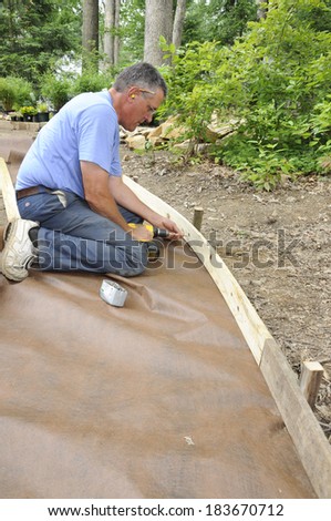 Man installing gravel path