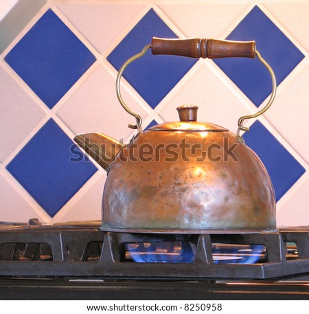 Copper tea kettle on gas range