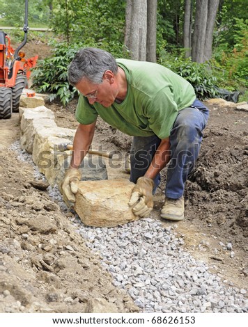 Man building stone wall