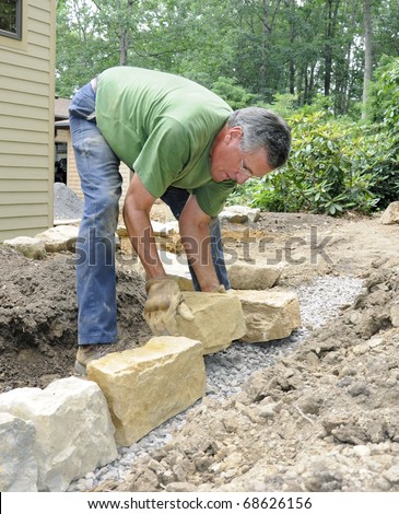 Man building stone wall