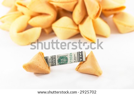 Chinese Fortune Cookie open with money, cash neatly folded inside the snack, on white background, many behind, to show one out of many.