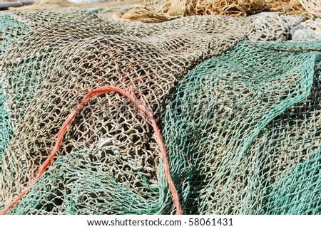 A mountain of fishing nets ready to be loaded on a fishing boat