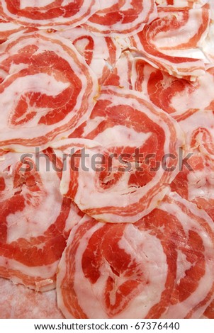 Slices of bacon rolled up ready for use in the kitchen
