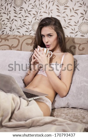 Sexy girl drinking coffee in the bed