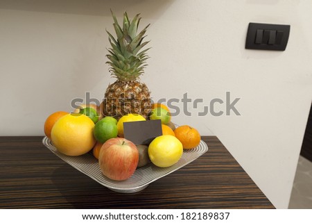 Fruit plate with empty business card in hotel room