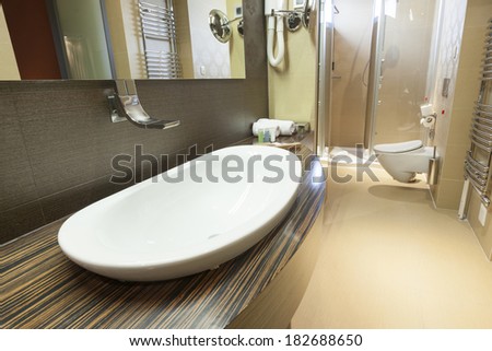 Modern tap and water basin in hotel bathroom